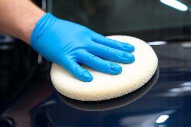 Hand polishing a car surface